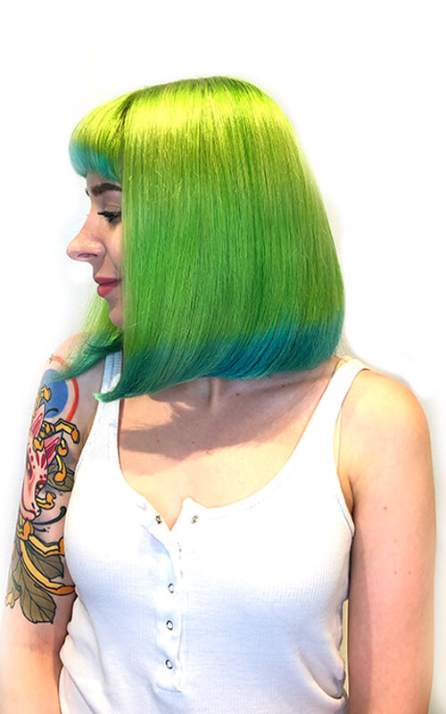 Hair model showing bright neon green hair with blue tips